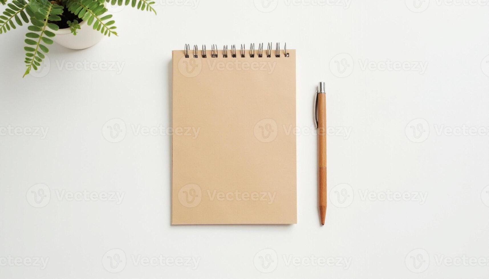 Notebook with pen and fern on white background photo