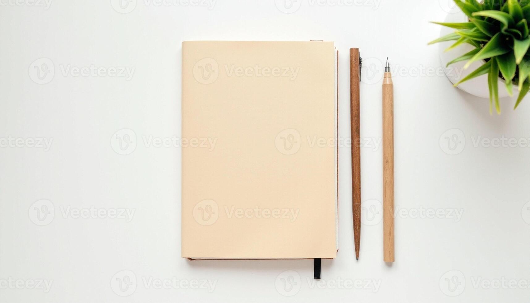 Notebook, pencil and plant on white background photo