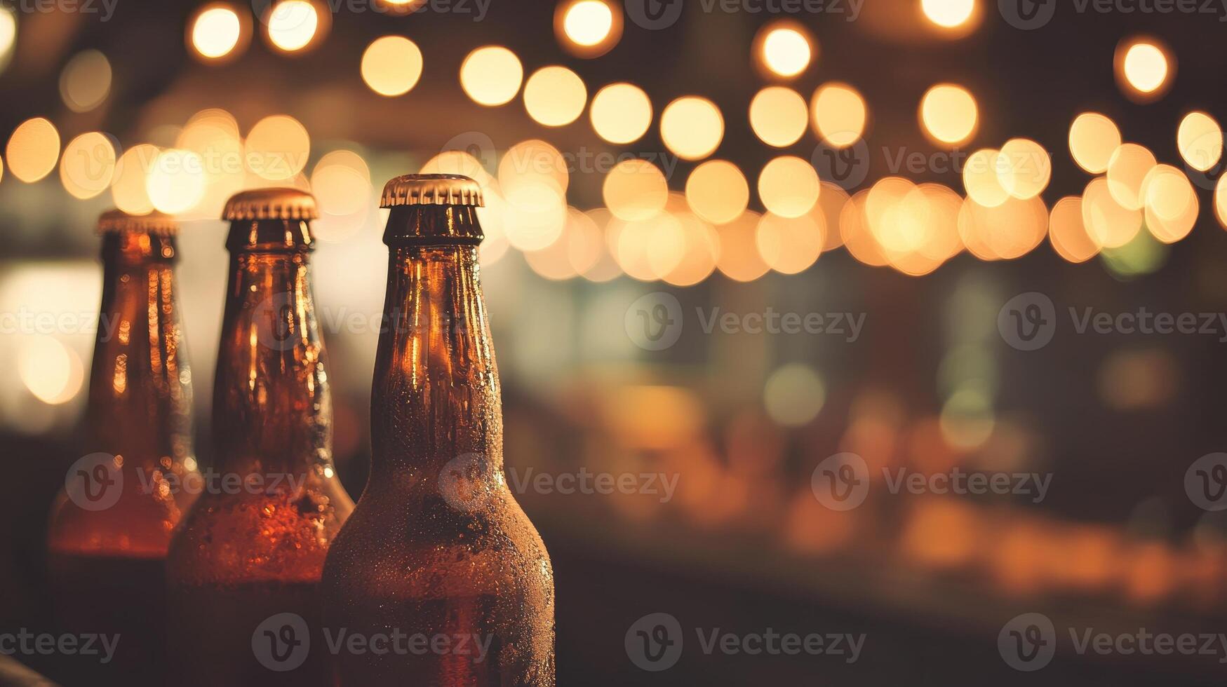 Chilled Beverages Three Brown Bottles in a Row Lit by String Lights photo