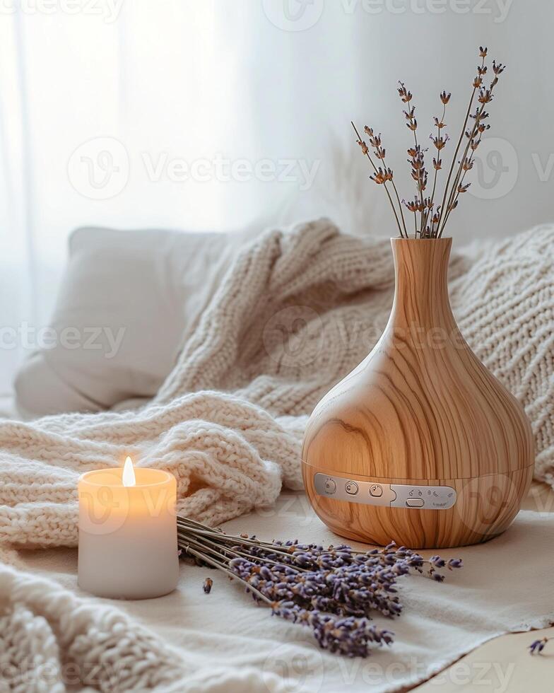 Wooden Diffuser, Candle, and Lavender on Knitted Blanket photo