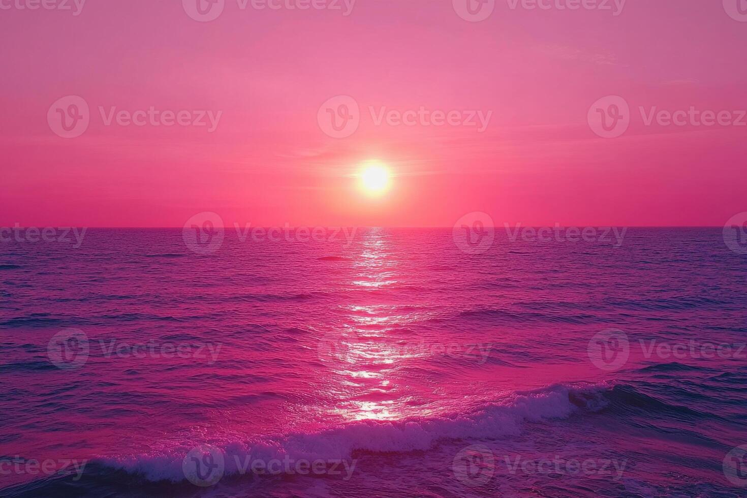 the sun is setting over the ocean in a pink sky photo