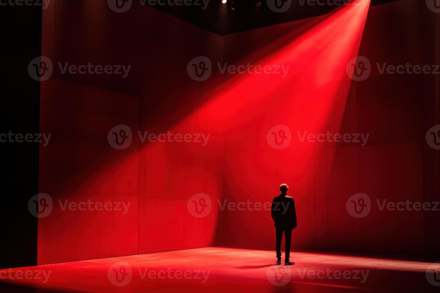 a man stands in the middle of a red room photo