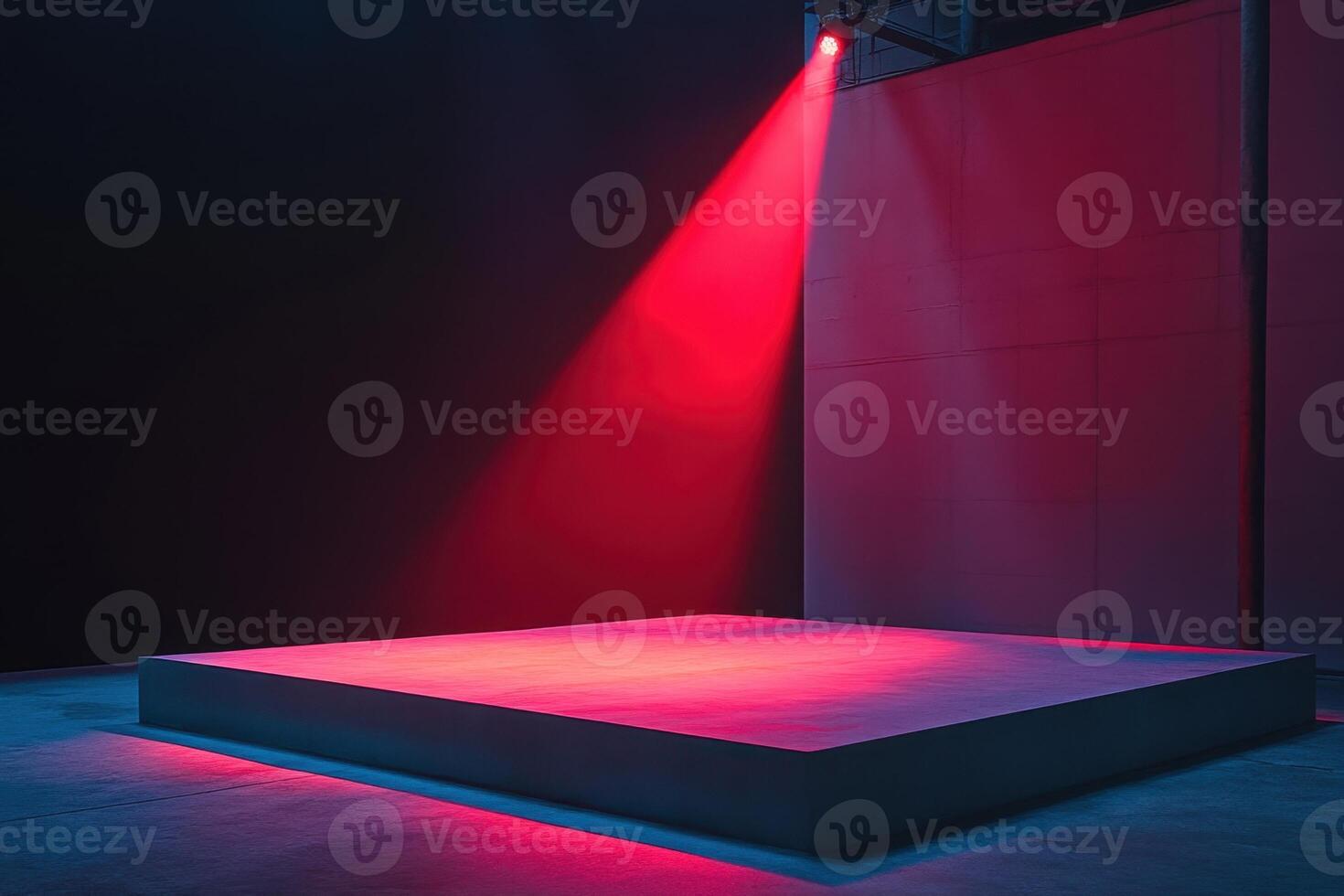 a red light shines on a stage with a white platform photo