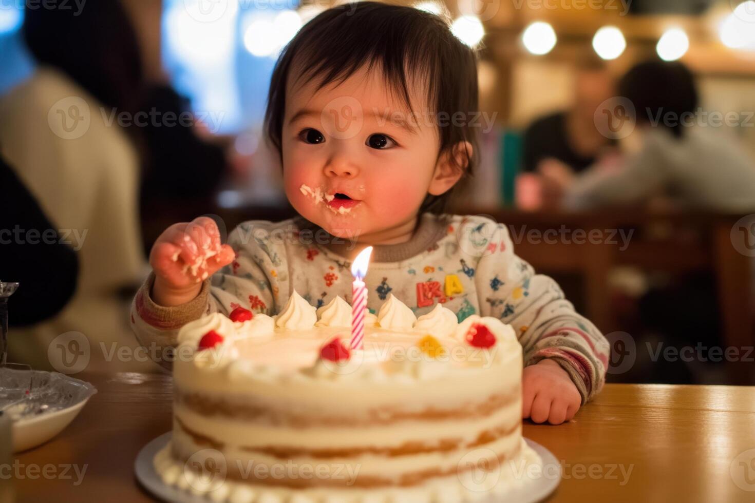 a baby is sitting in front of a cake with a lit candle photo