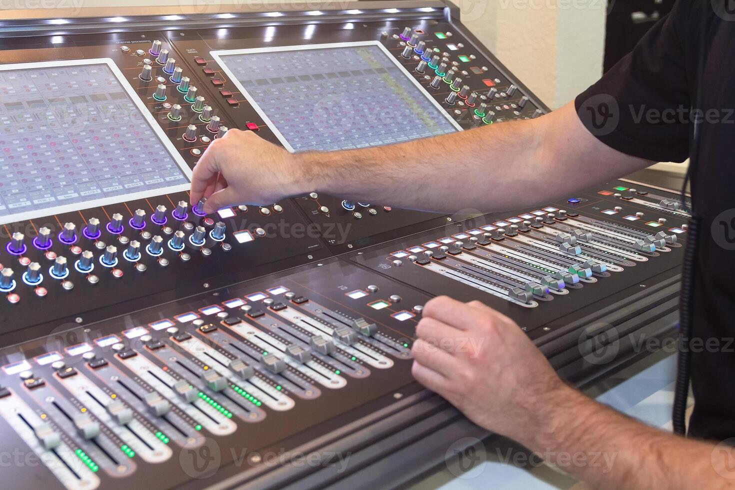 Sound engineer hands adjusting control sound mixer. Music photo