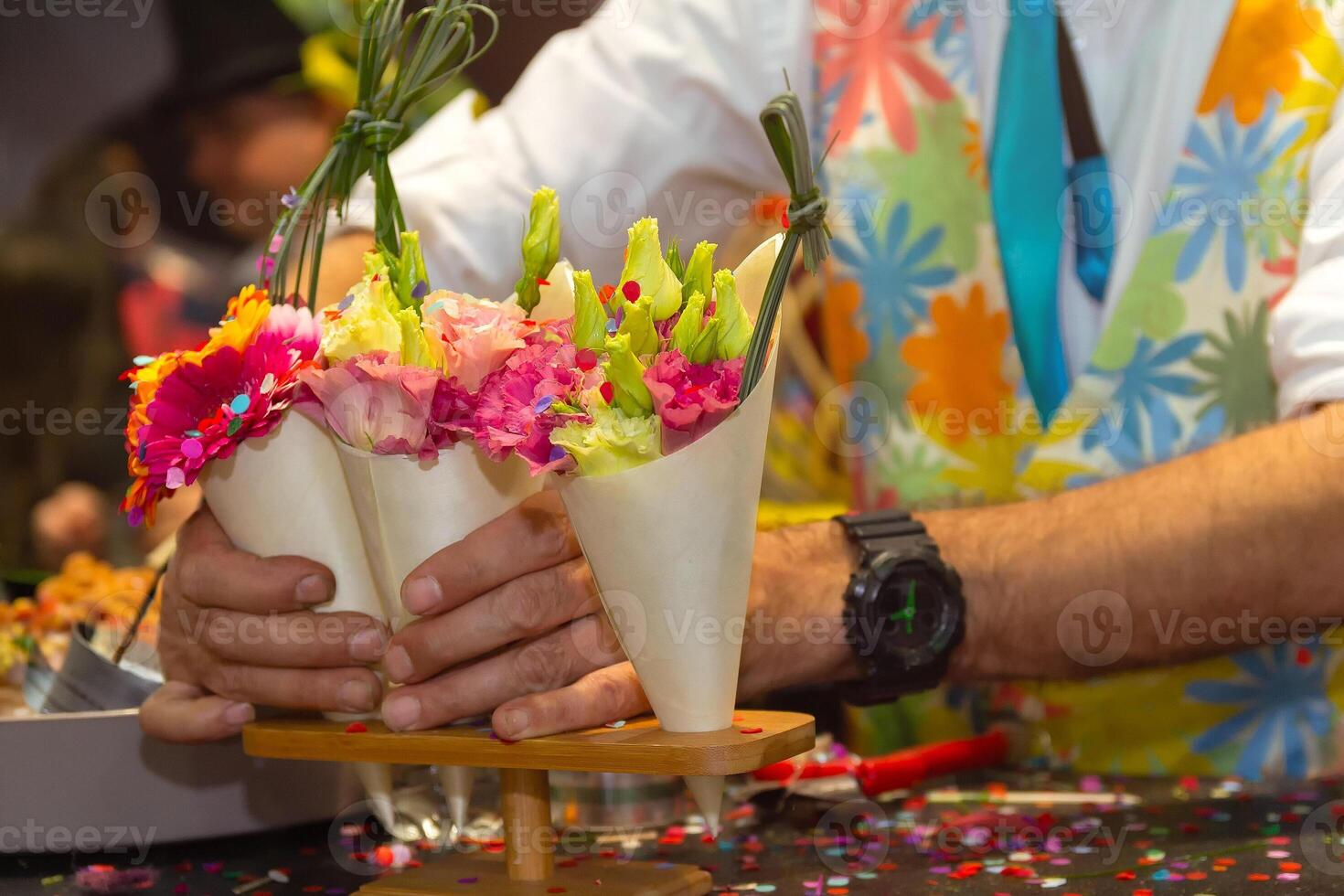 Hands of a man which in a beautiful bouquet of flowers photo