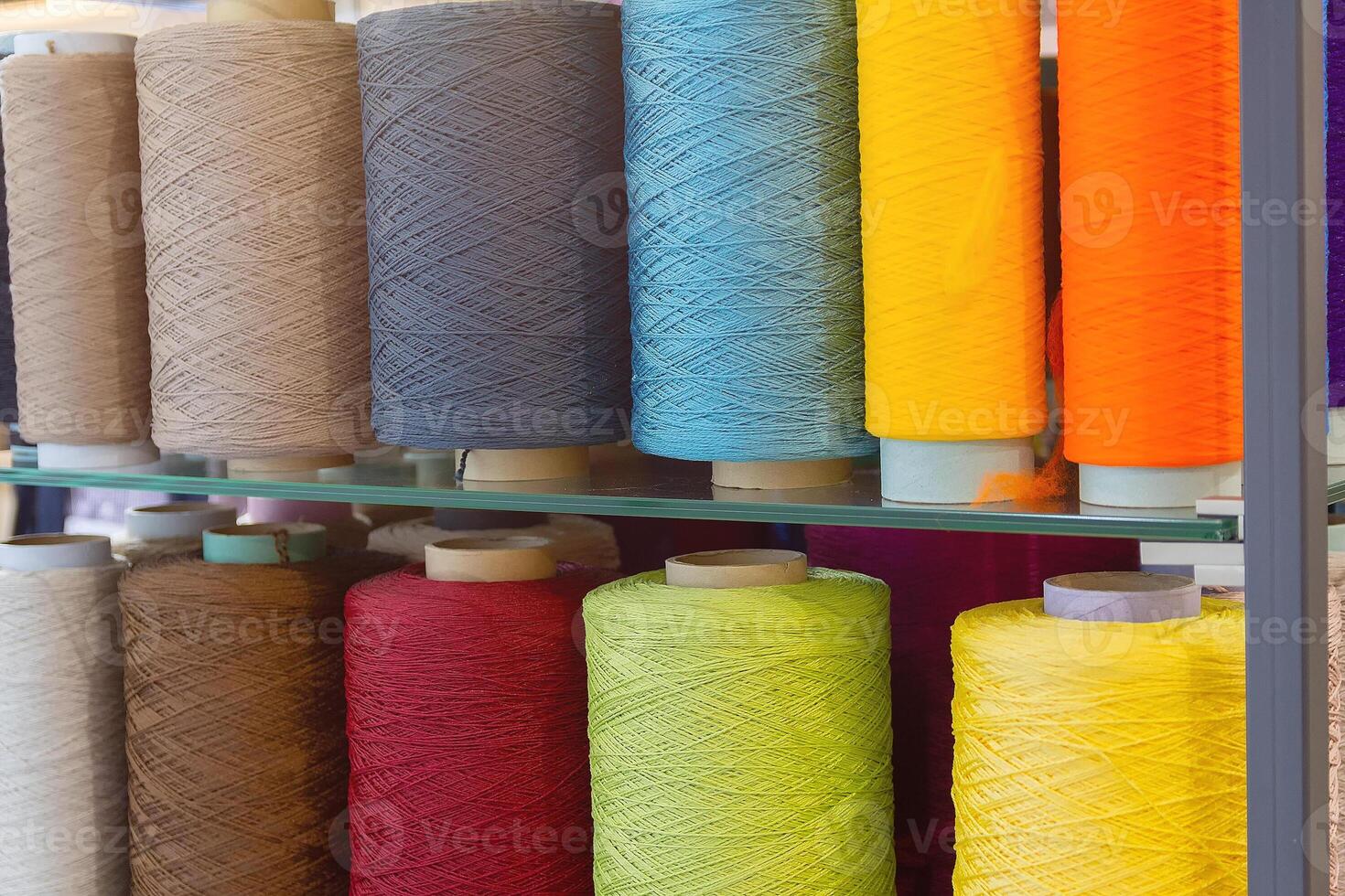 Multi-colored threads at the exhibition stand. Industry photo
