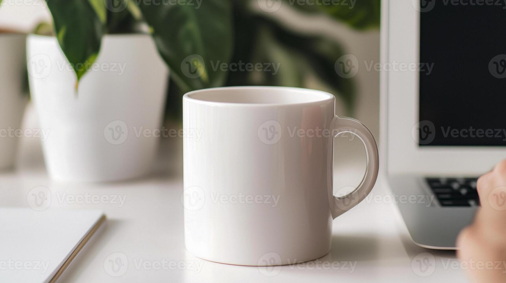 Man's Hand Reaching for a White Mug on a Desk photo