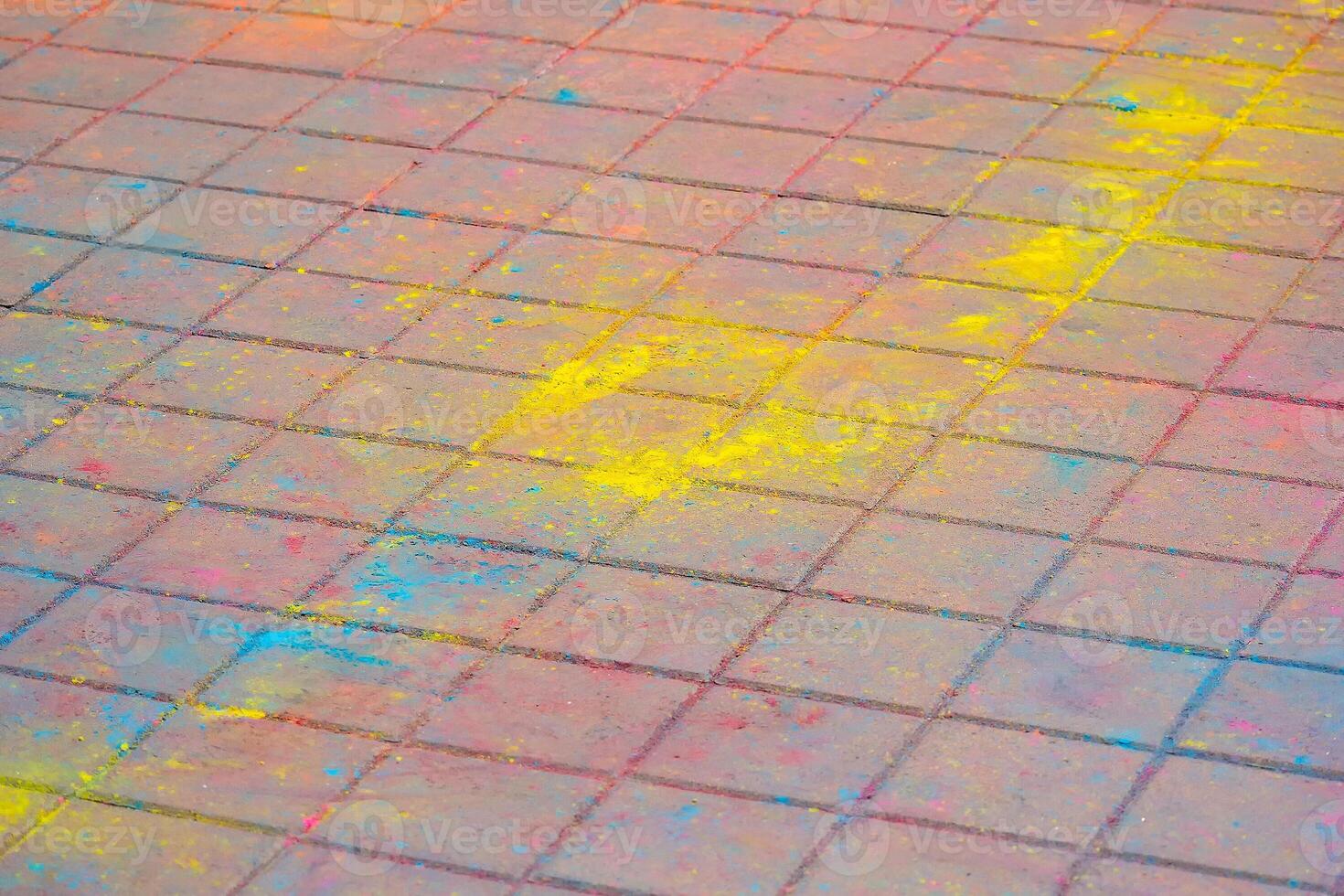 Multi-colored earth, paving slabs, powder coated with dry colors at the Holi festival photo