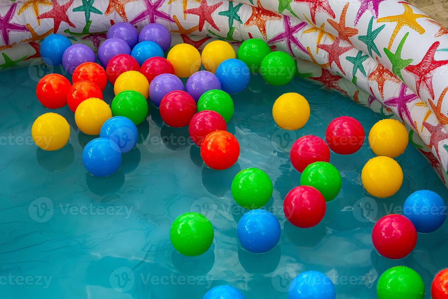 Colorful plastic balls in the pool photo