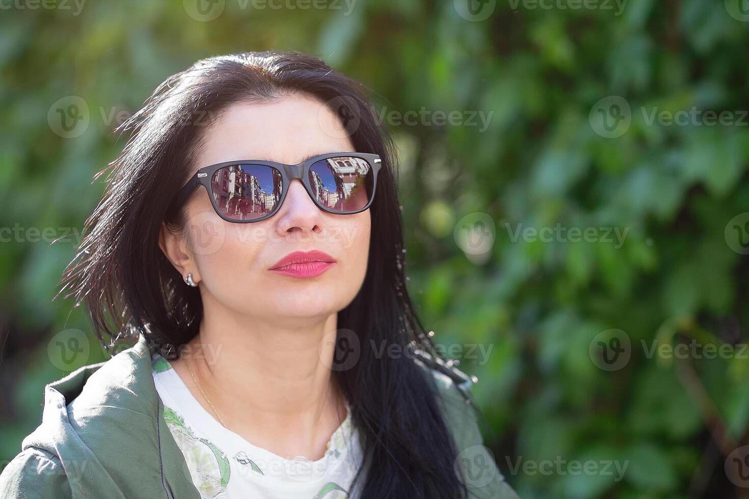 Woman wearing sunglasses in the garden. People photo