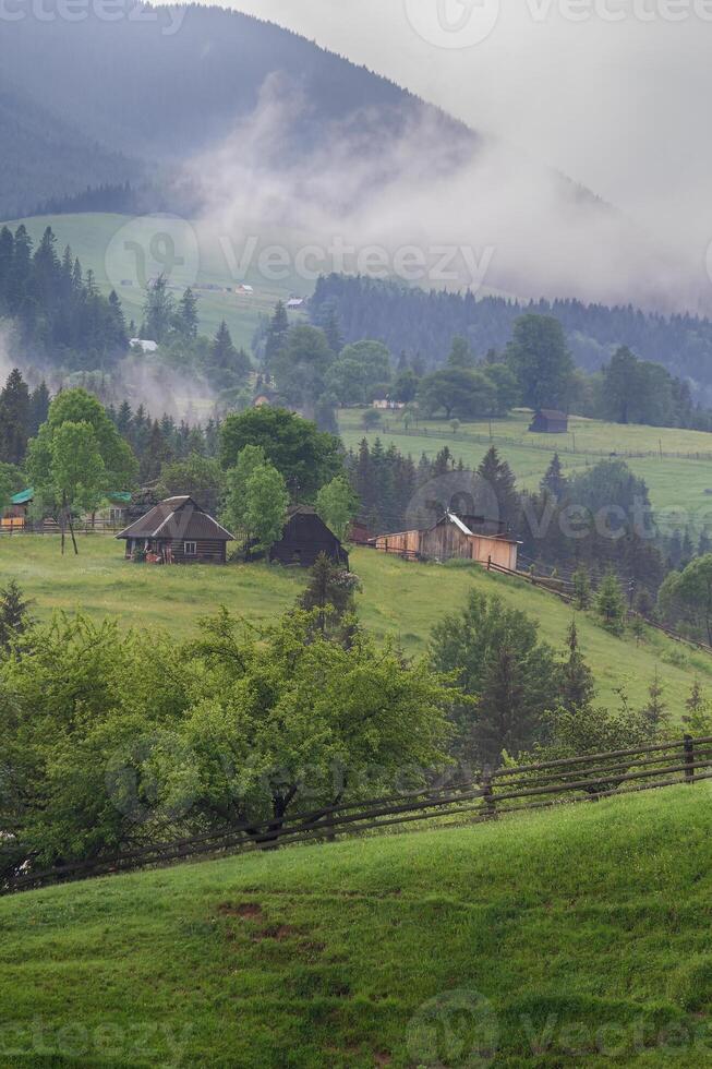 Views of the mountains and village in the morning fog. Carpathians photo