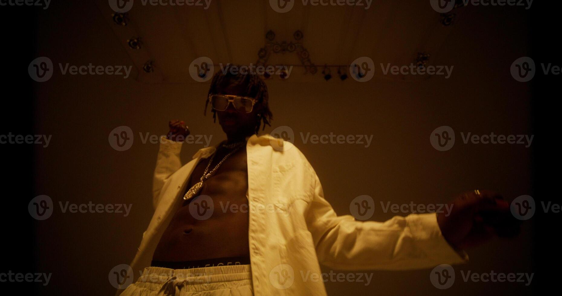 An man is dancing in the studio by the light of flashes. photo