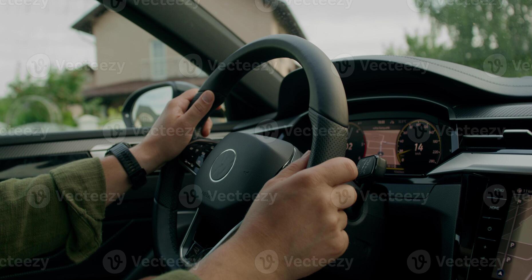 A man drives a car. Close-up of his hands on the steering wheel, an unrecognizable person. View from the car interior. photo