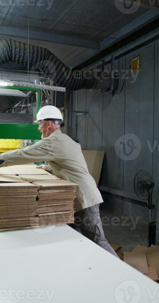A man works in a paper mill. photo
