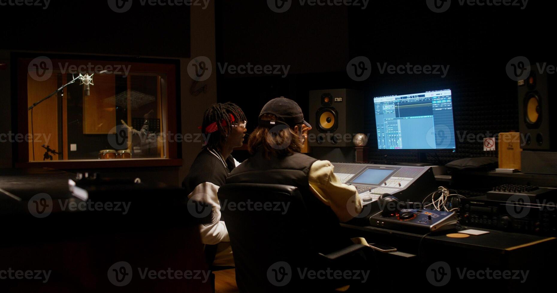 Collaboration in a recording studio. Listening to a song after recording photo