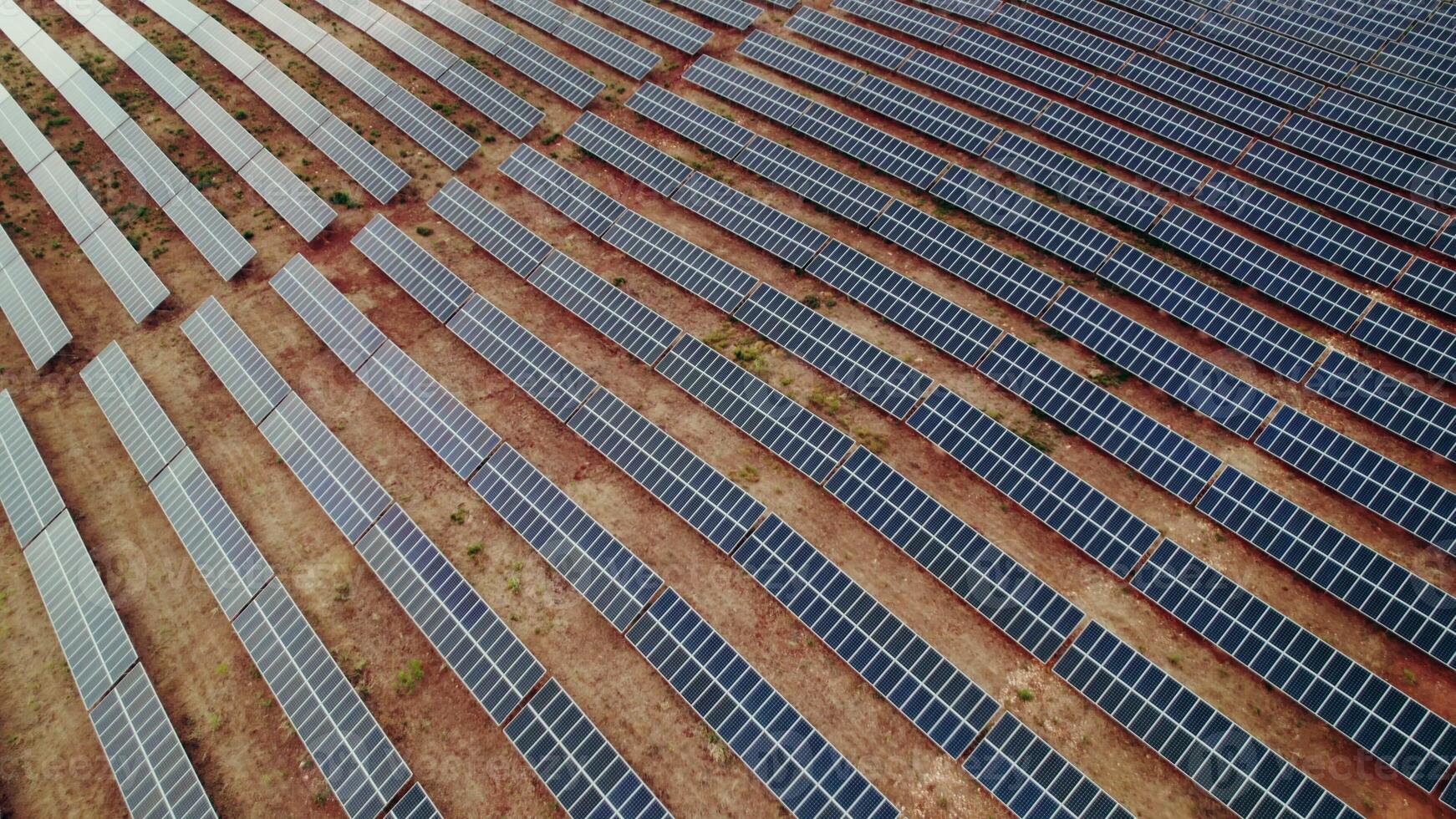 A lot of solar panels lie in lines on a deserted land, a bird's-eye view photo
