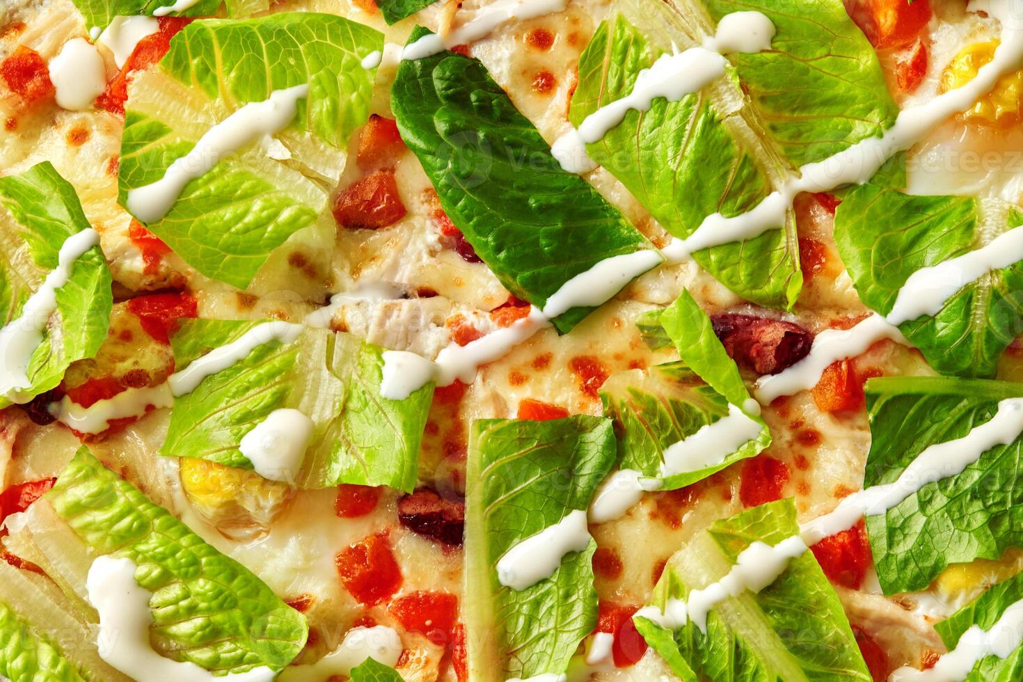 Delicious caesar salad pizza with romaine lettuce and creamy dressing photo