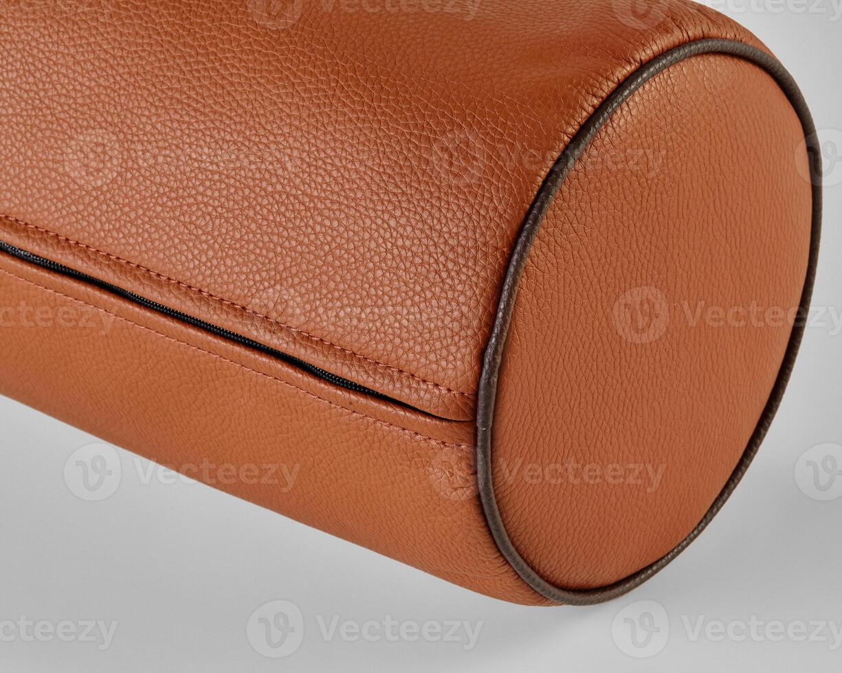 Close-up of cylindrical leather object showing stitching and texture photo