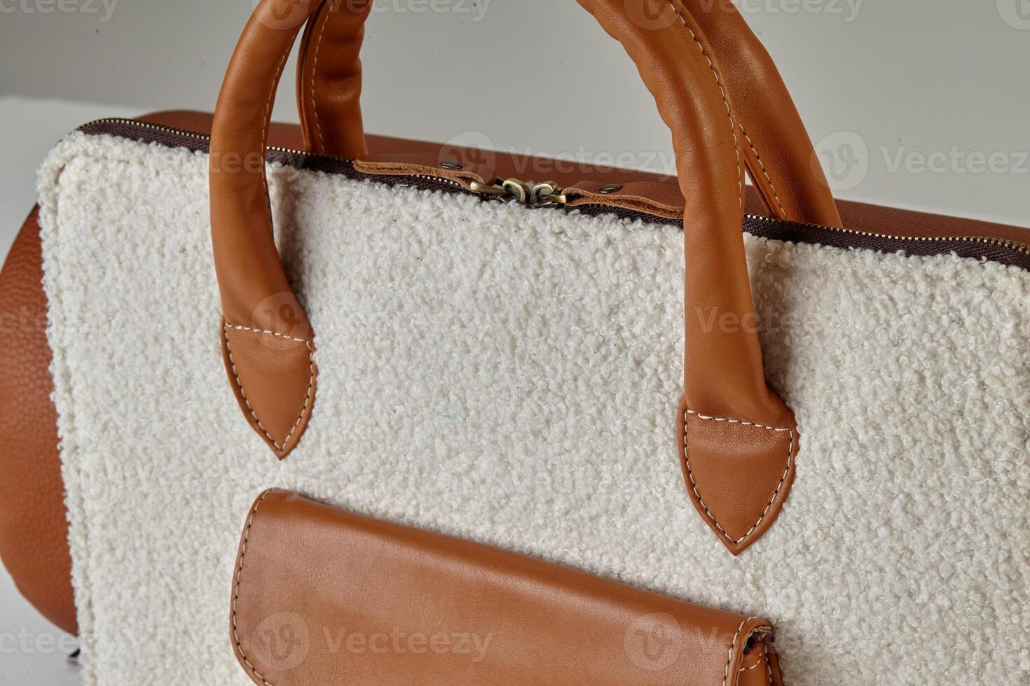 Stylish white sherpa bag with brown leather handles and pocket photo