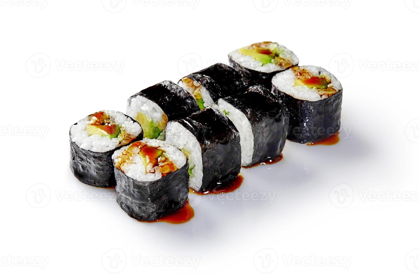 Delicious sushi rolls with eel, avocado, and unagi sauce drizzled on white background photo