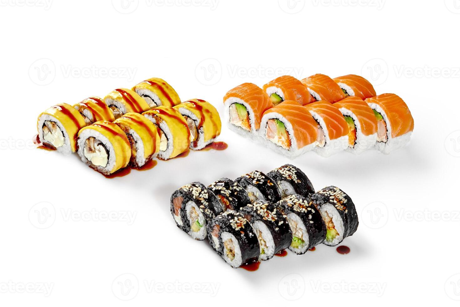 Sushi rolls covered with sesame and topped with sauce presenting variety of japanese food photo