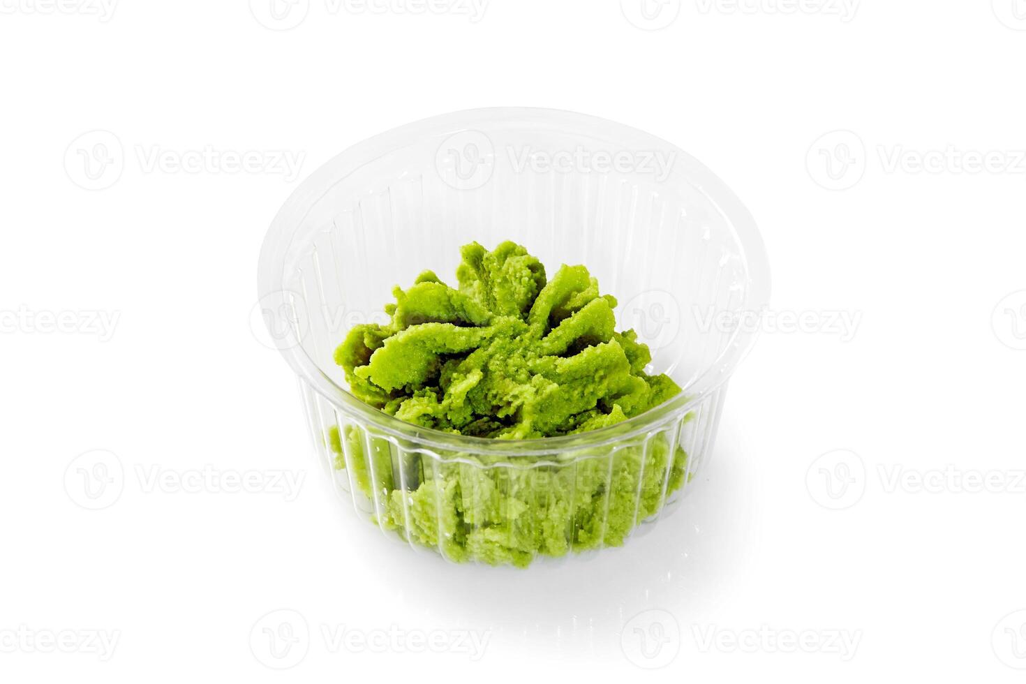 Wasabi paste in plastic container on white background photo