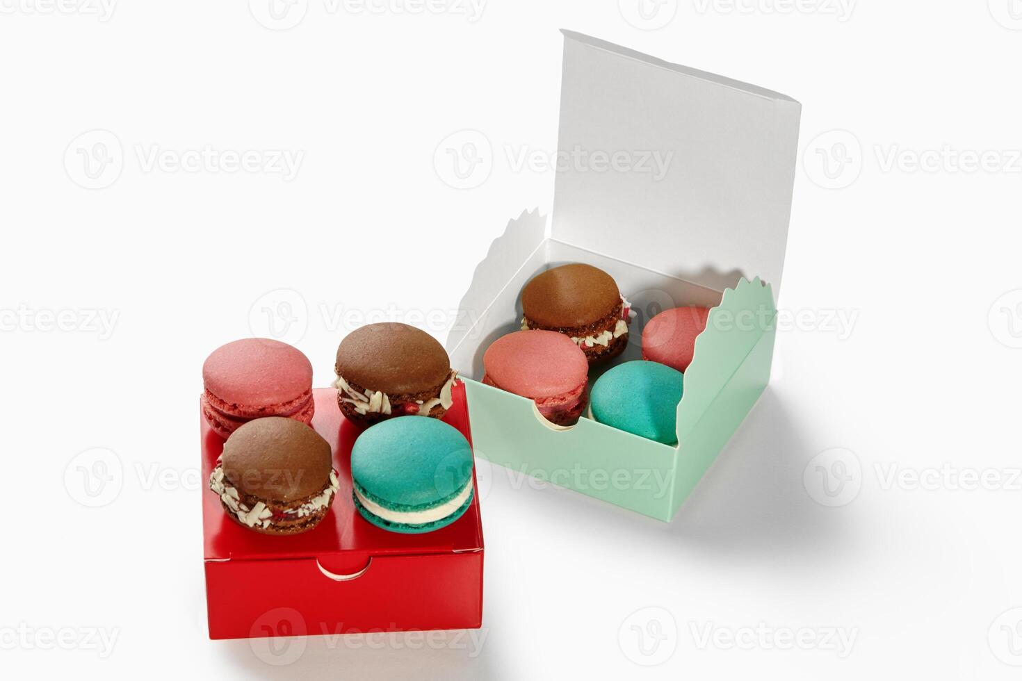 Colorful macarons resting in gift boxes on white background photo