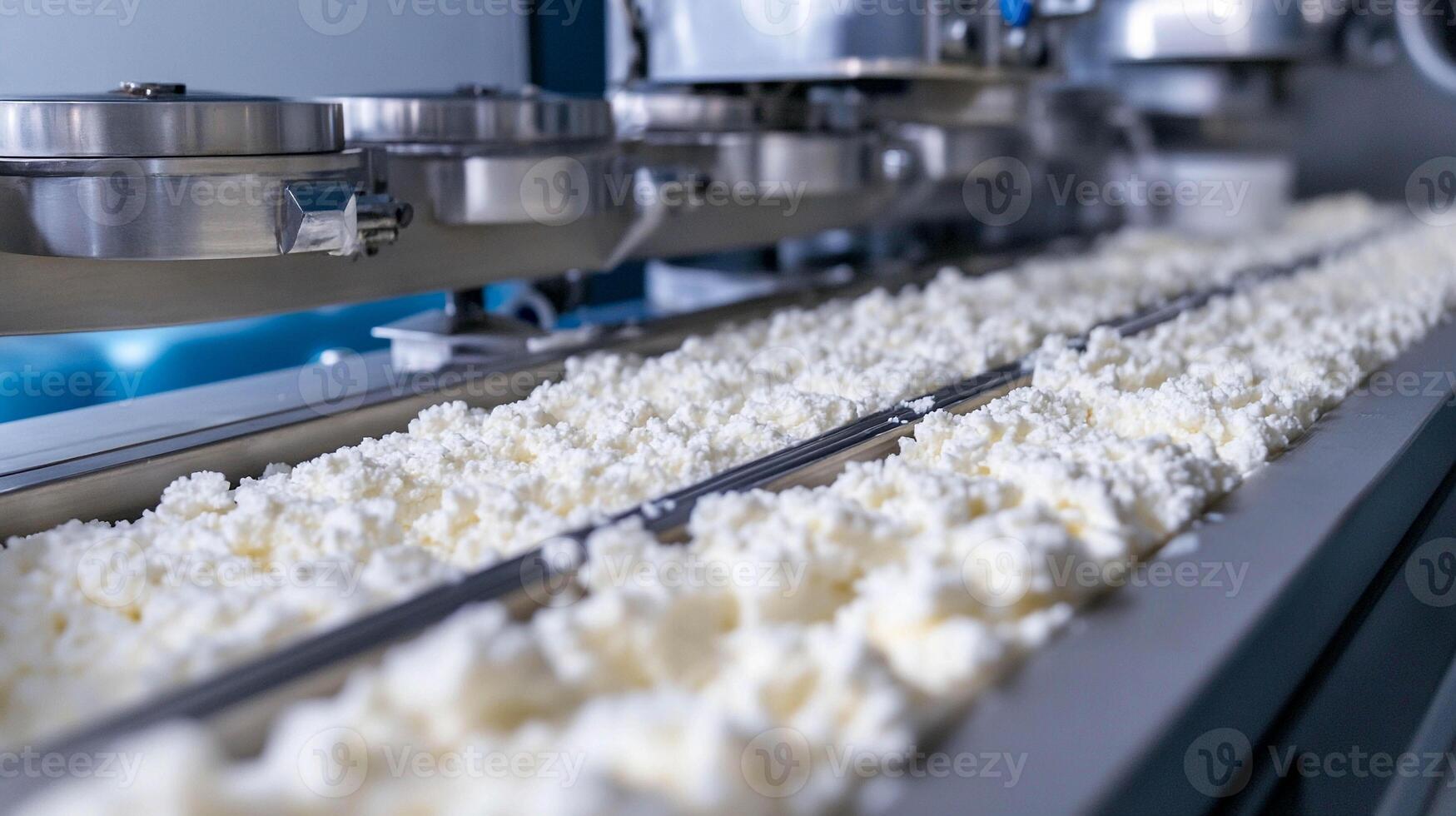 Fresh dairy product being processed on conveyor belt in modern factory during daylight hours photo