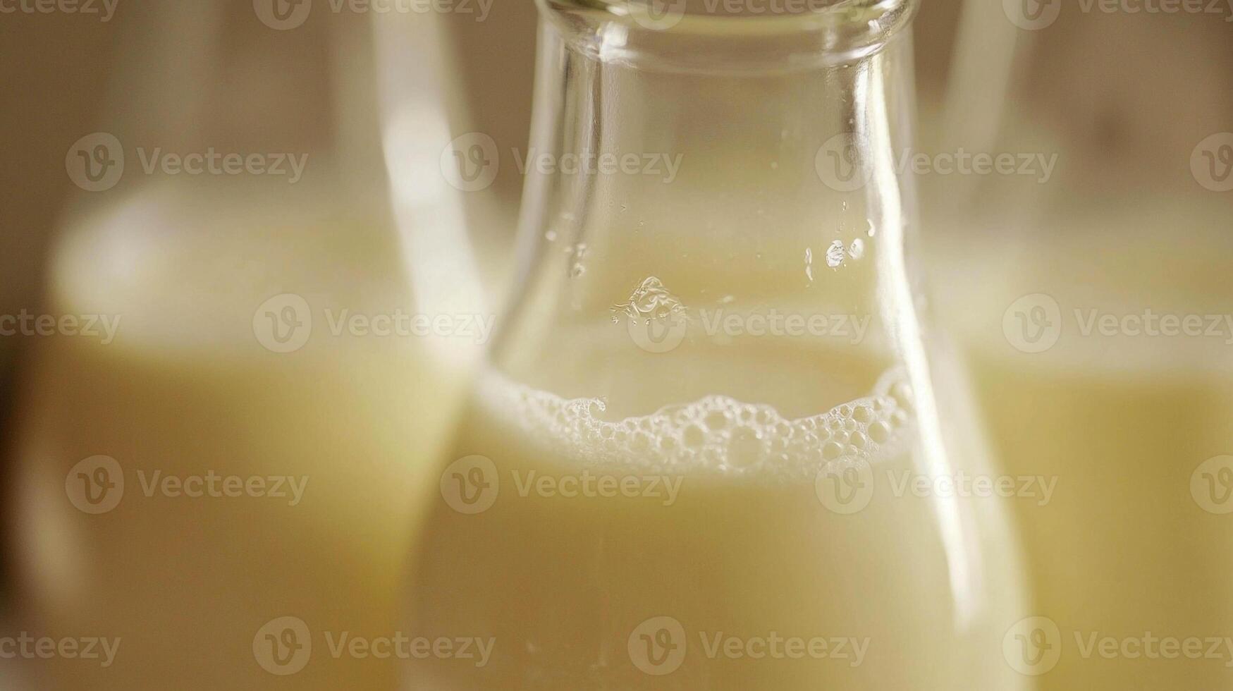 Milk in glass bottles, freshly poured and ready for serving at a rustic kitchen setting photo