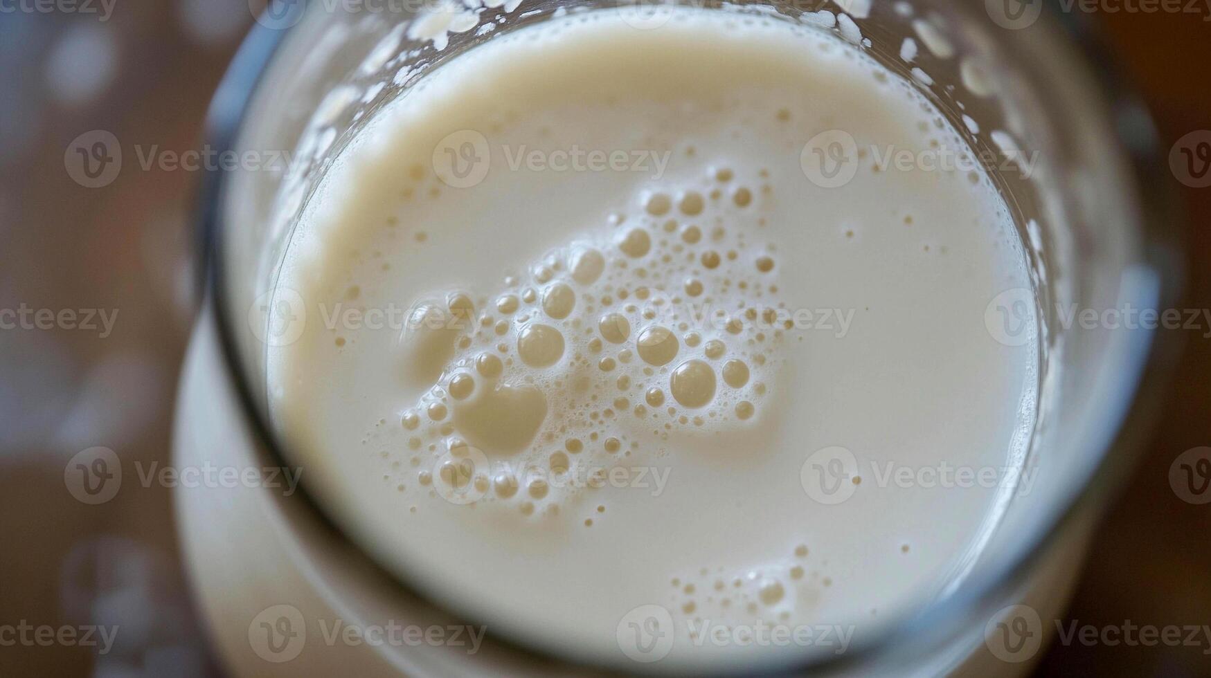 Freshly poured milk with bubbles in a glass ready for enjoyment and nutrition photo