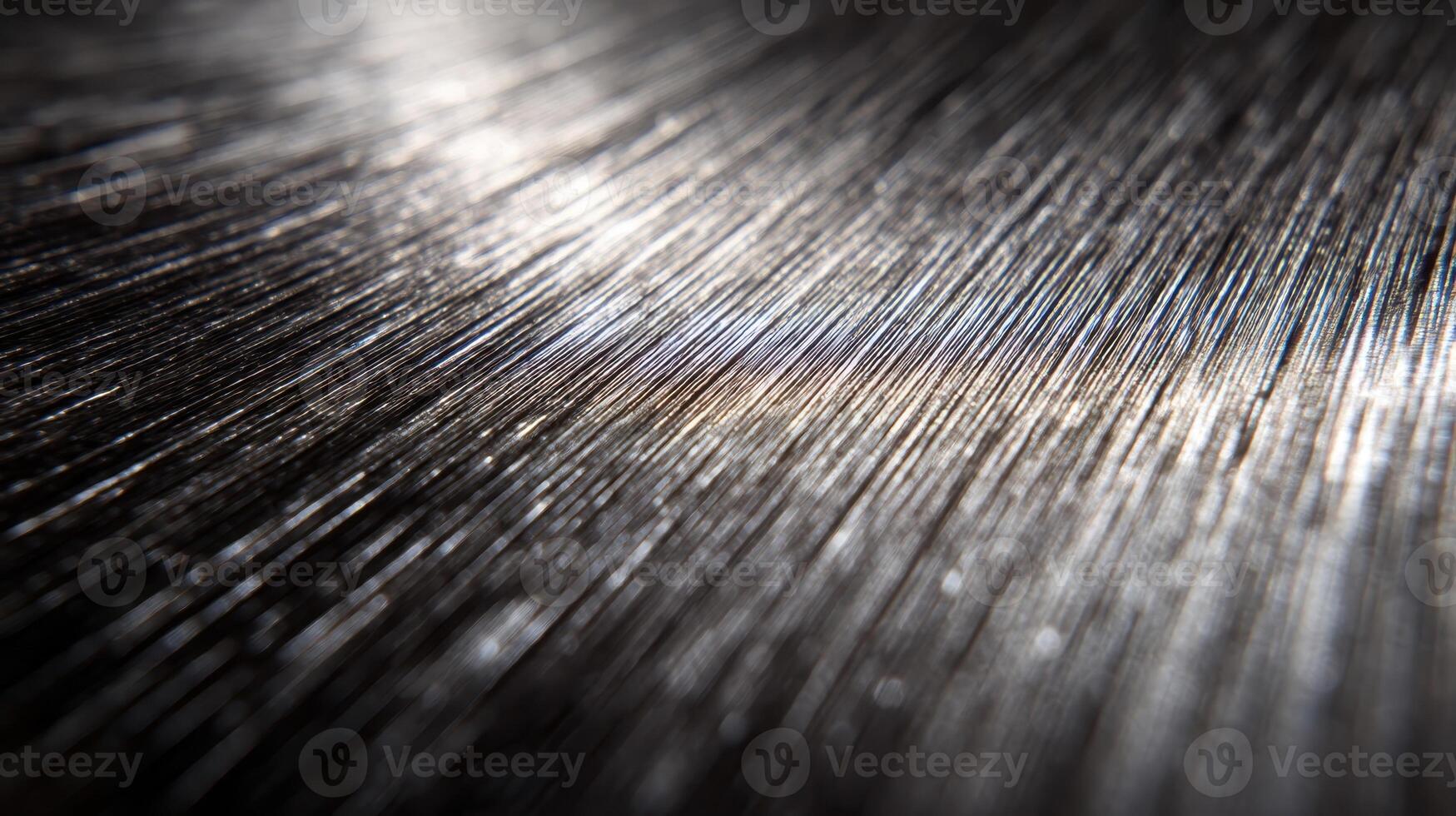 Close view of vertically brushed aluminum highlighting light reflections and texture details photo