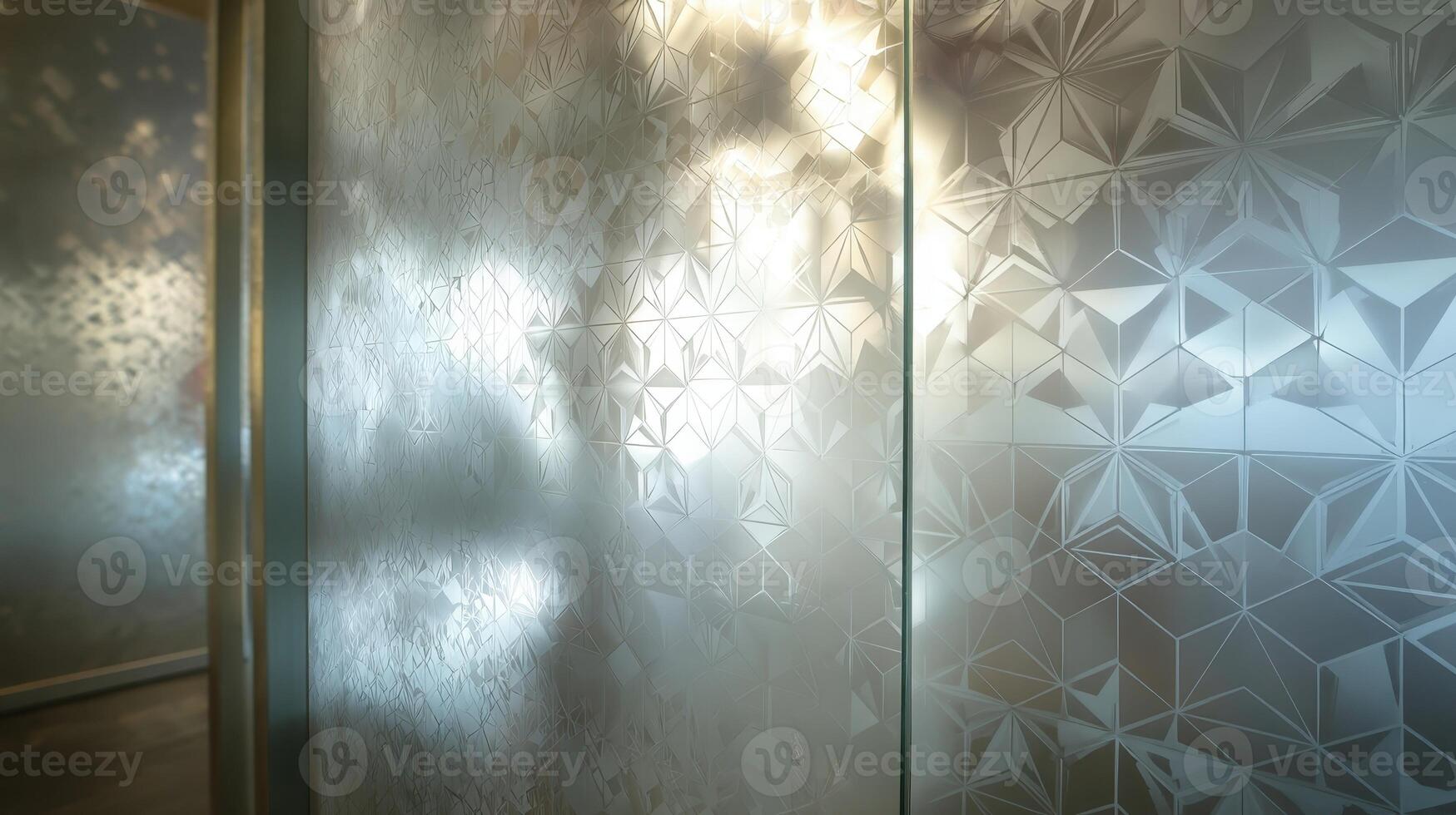 Geometric etched pattern on a glass surface reflecting soft light in an interior space photo