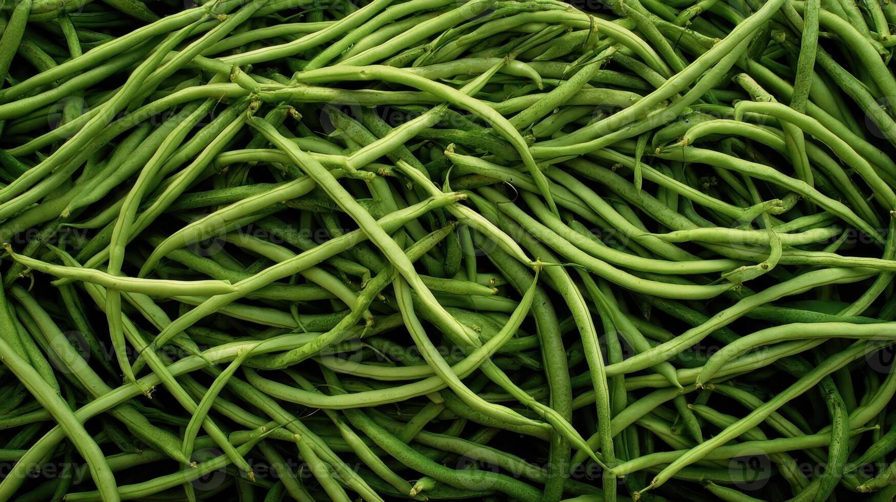 Dense arrangement of fresh green beans showcasing their long shape and vibrant color in a market setting photo