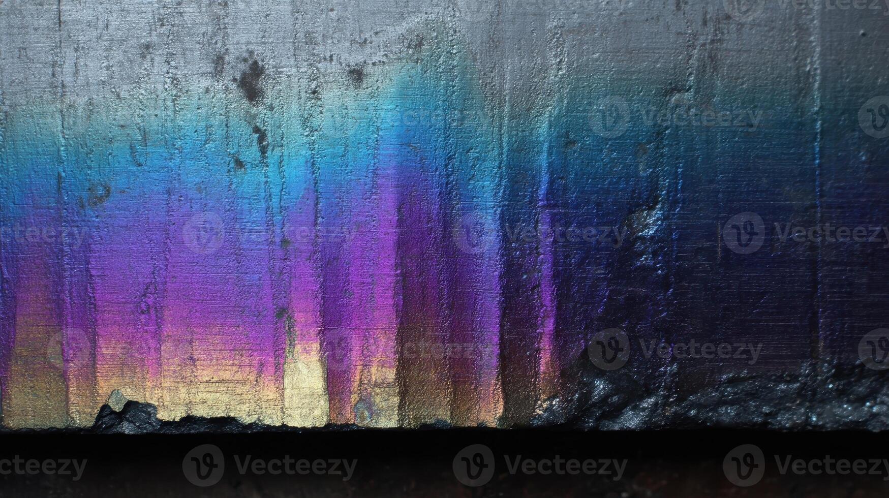 Titanium surface revealing vibrant blue and purple oxidation patterns under natural light photo