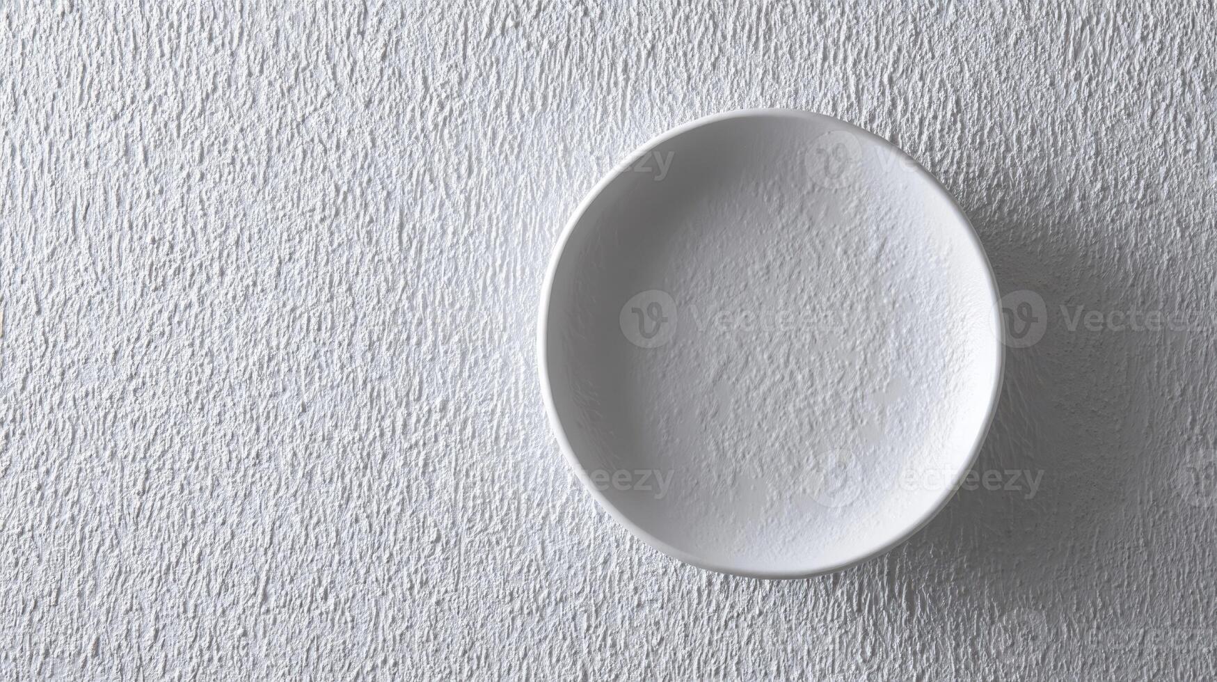 Ceramic white plate on textured surface ideal for minimalistic table settings and modern decor photo