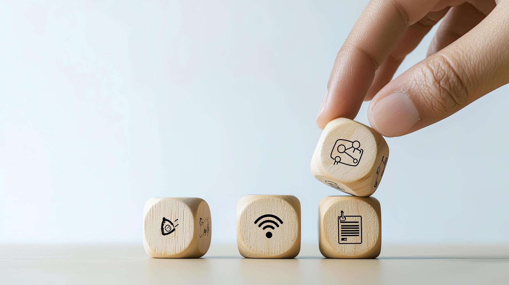 Hand Stacking Wooden Blocks with SEO, Wifi, Project Management, Goal Setting, and Contract Icons for Business Strategy photo