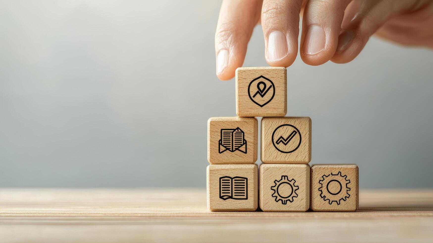 Building Blocks of Business Strategy Hand Stacking Wooden Cubes with Icons for Planning and Success photo