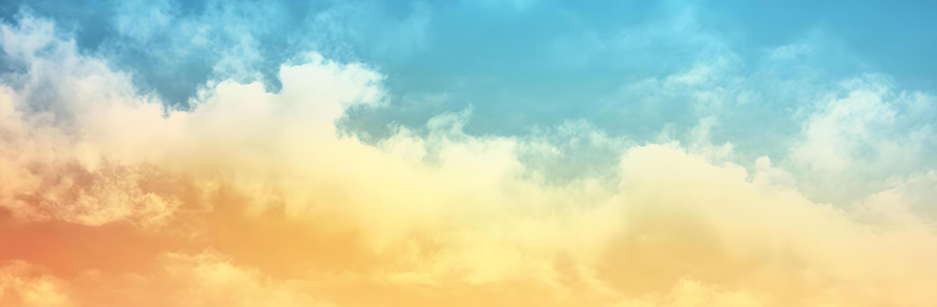 A mesmerizing gradient of blues and yellows illuminates wispy clouds in the expansive sky photo