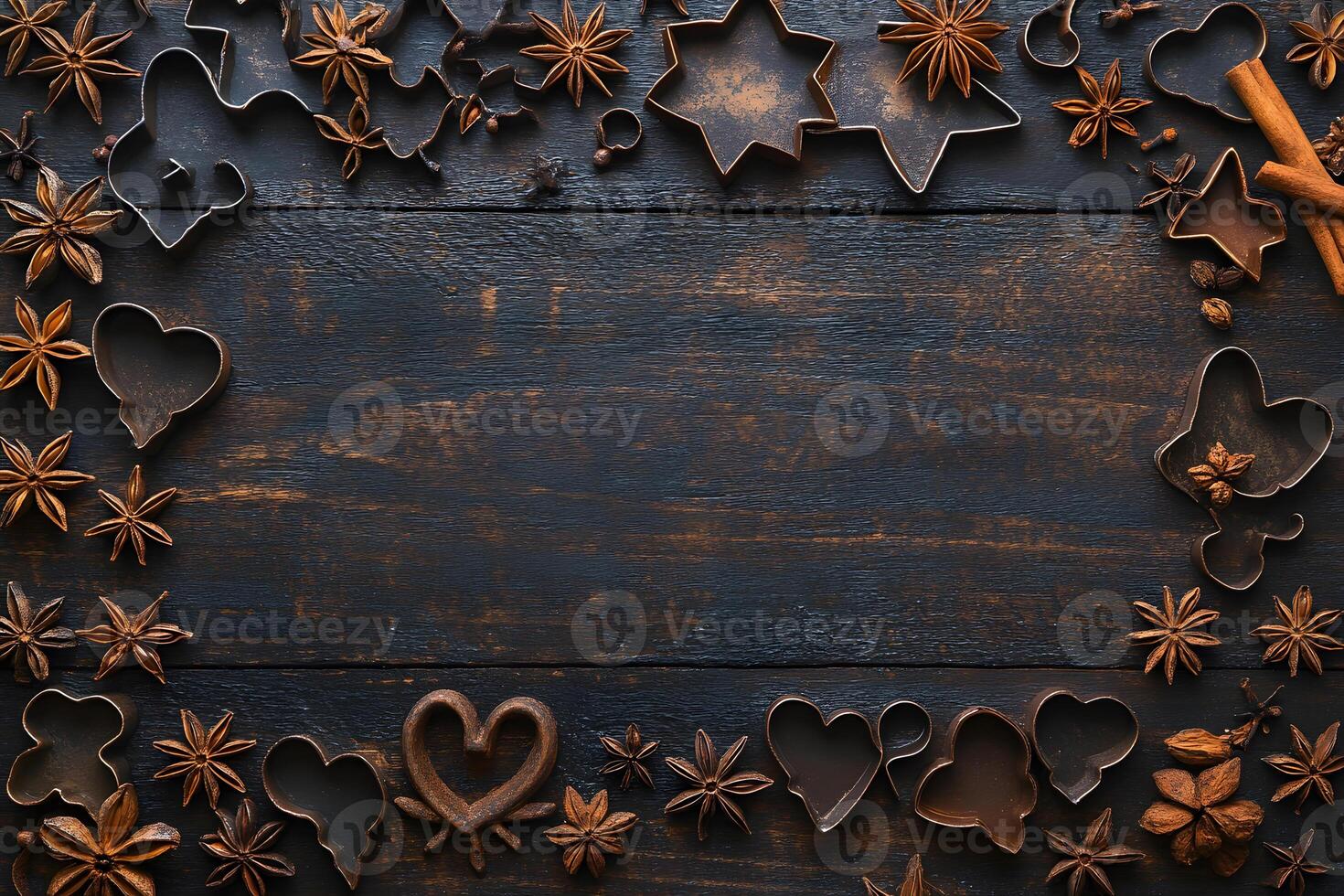Cookie cutters and star anise create festive borders on a dark wooden surface elegantly photo