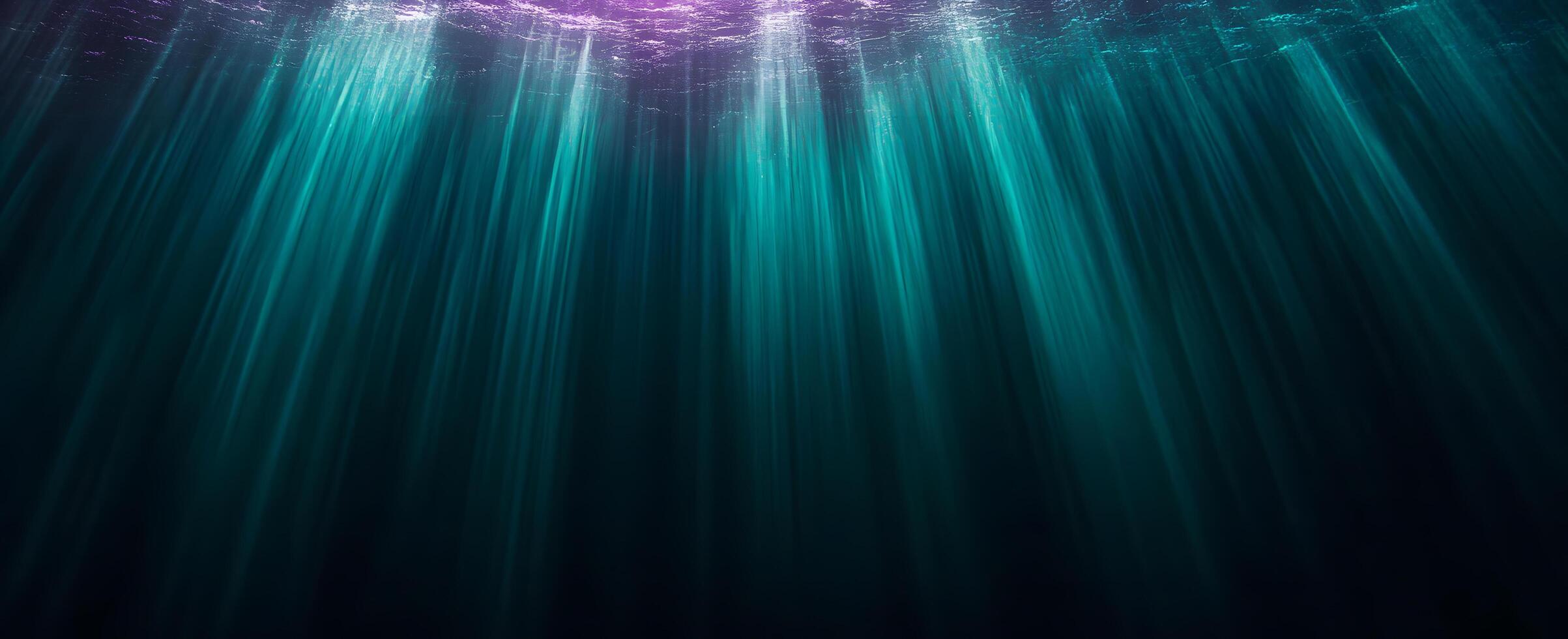 Sun's light creates turquoise rays piercing deep through the ocean water from a purple surface photo