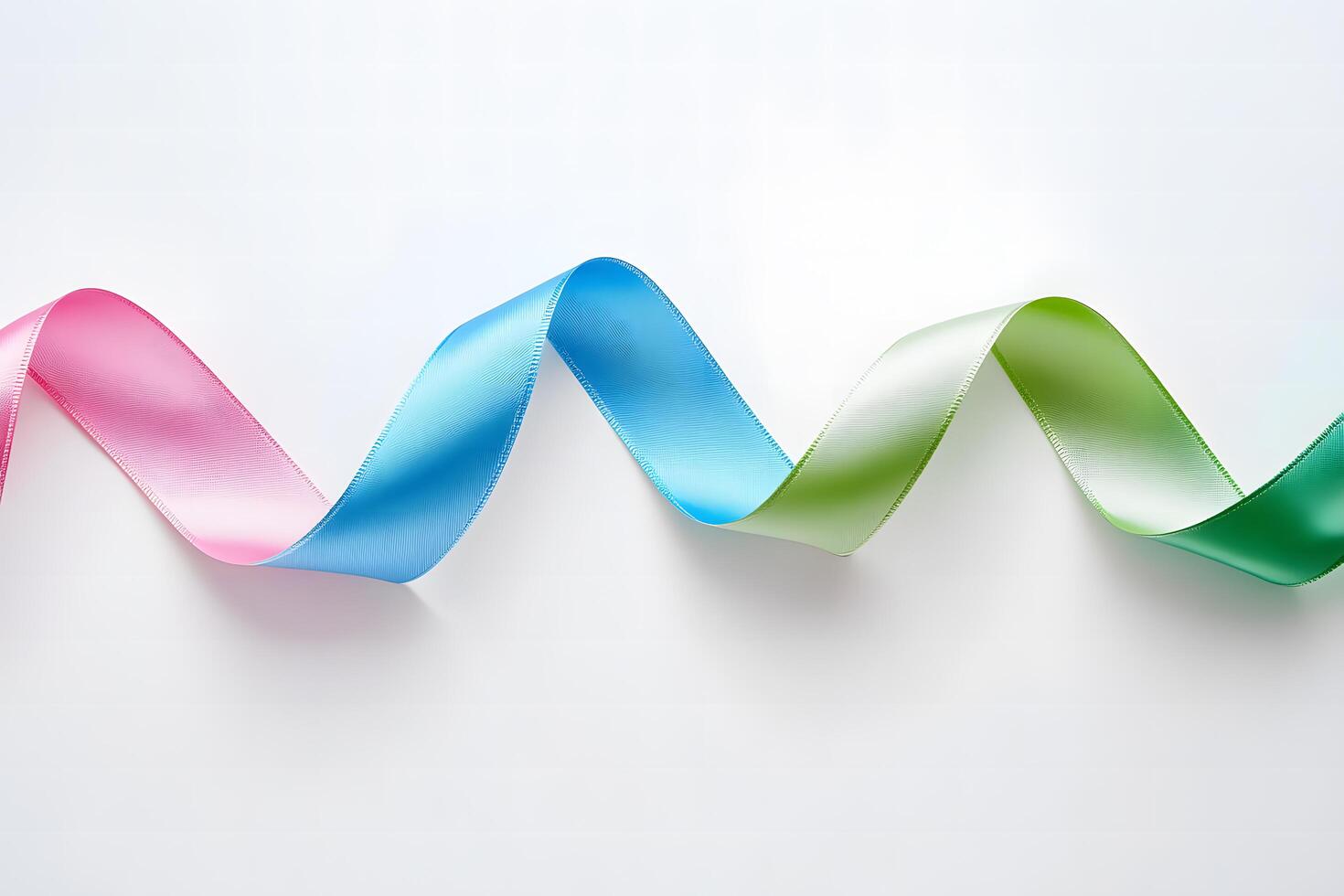 Colorful ribbon cascades across the white surface, displaying a beautiful transition from pink to green photo
