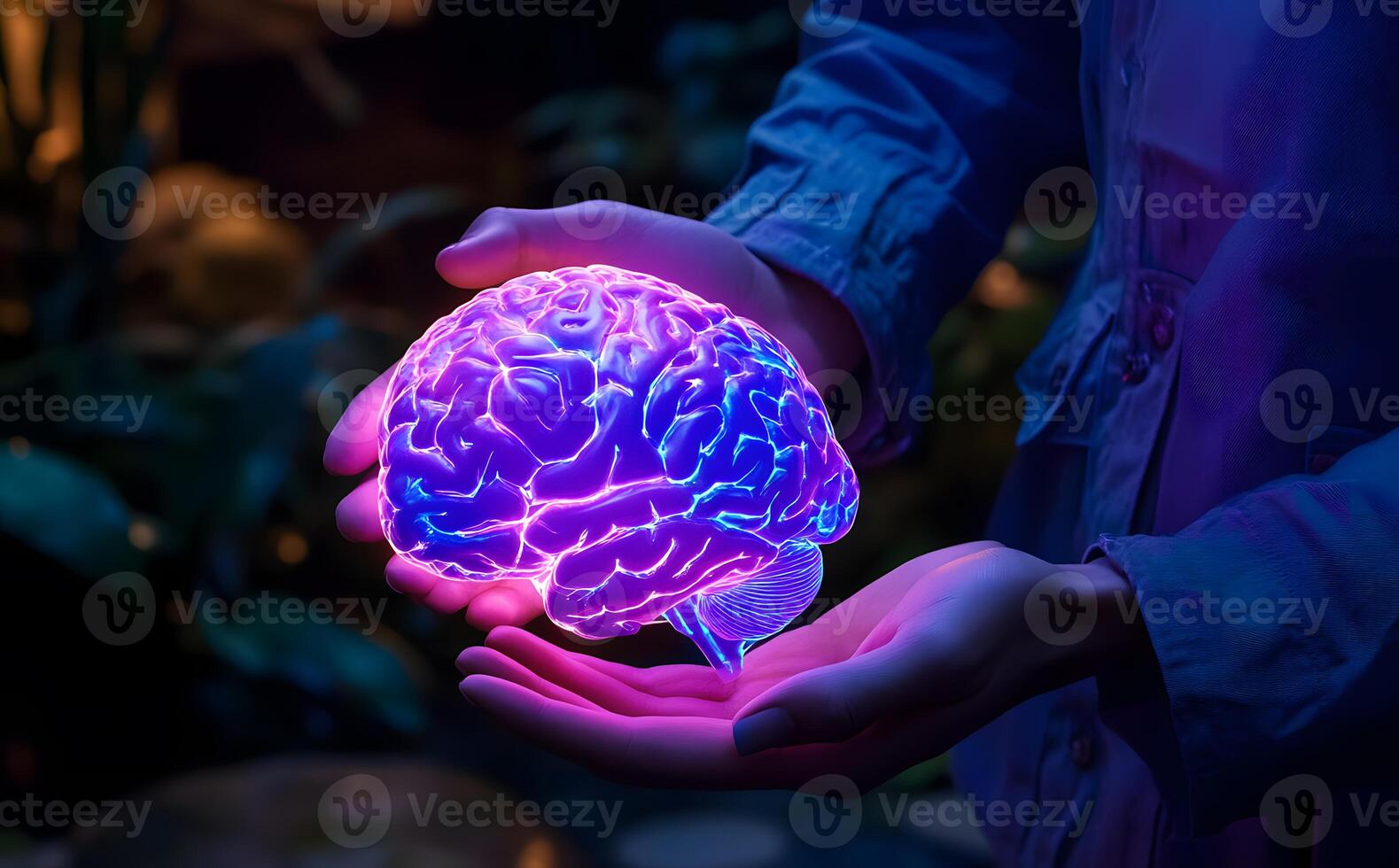 A person holds a glowing blue and purple human brain in their open palms photo