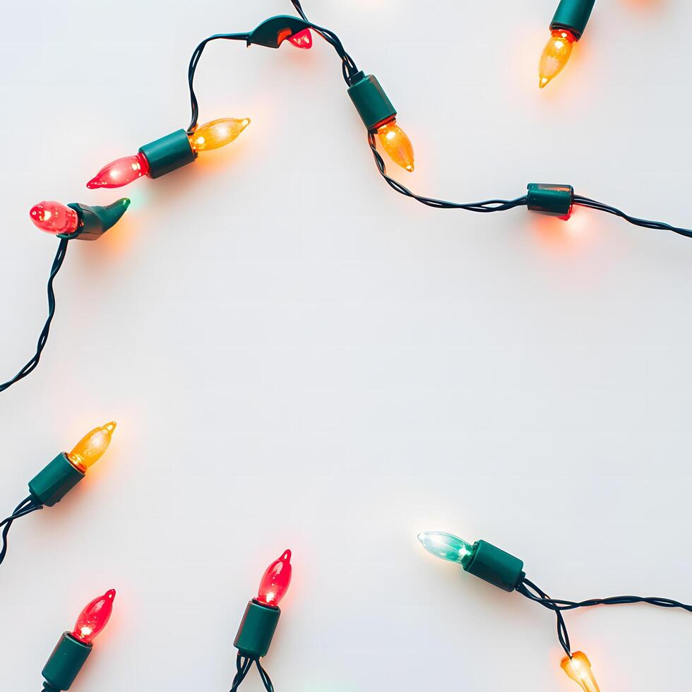 Festive string lights in red, green, yellow, and orange illuminate the bright white background photo