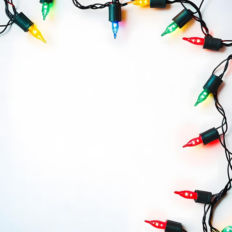 Colorful christmas lights are glowing on a white backdrop, creating a festive border photo