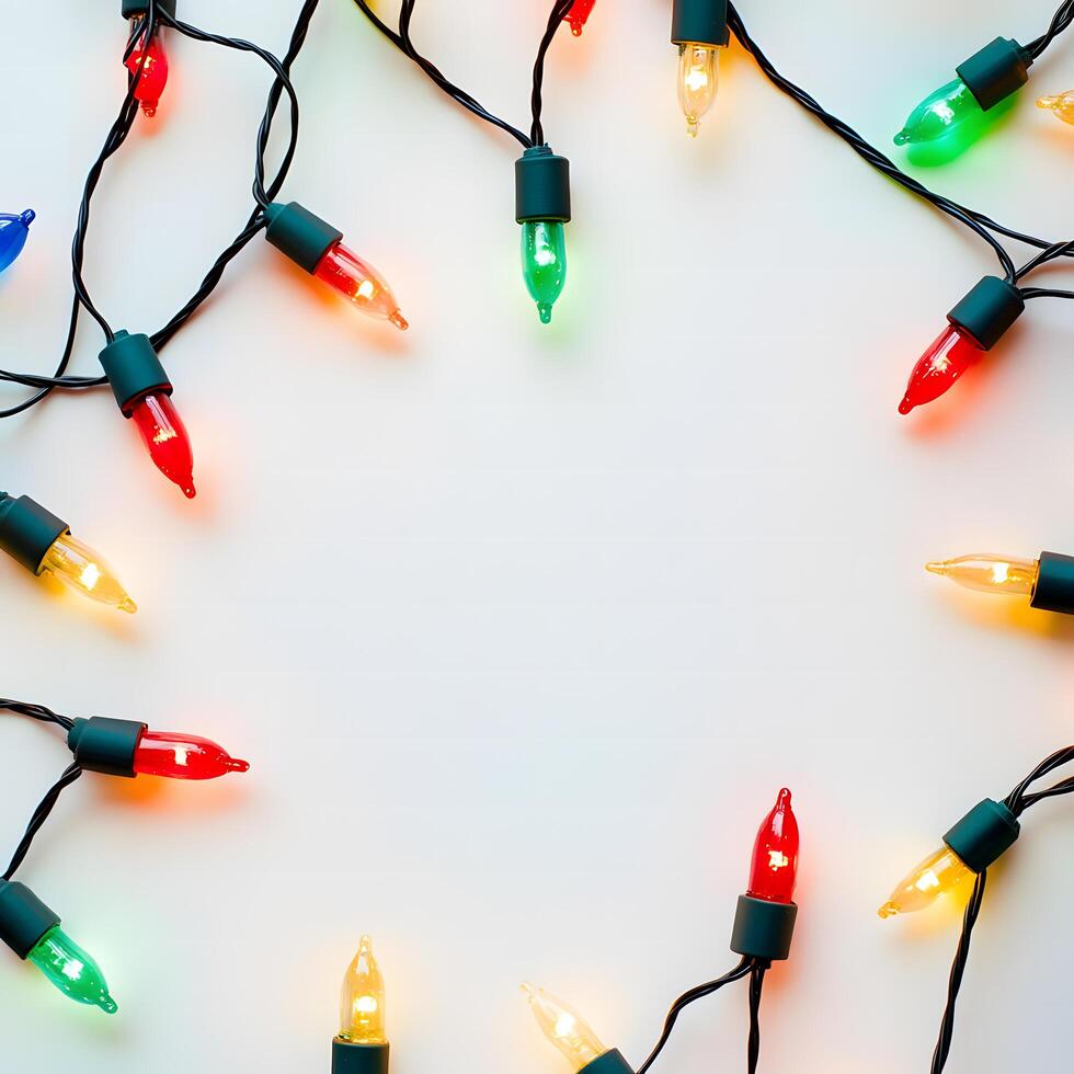 Assorted colored lights are arranged in a circle with a black wire against white photo