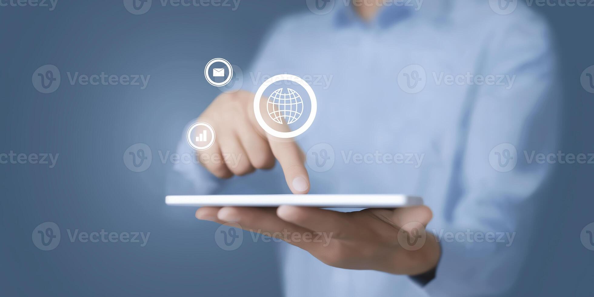 Businessman using tablet with icons on screen photo