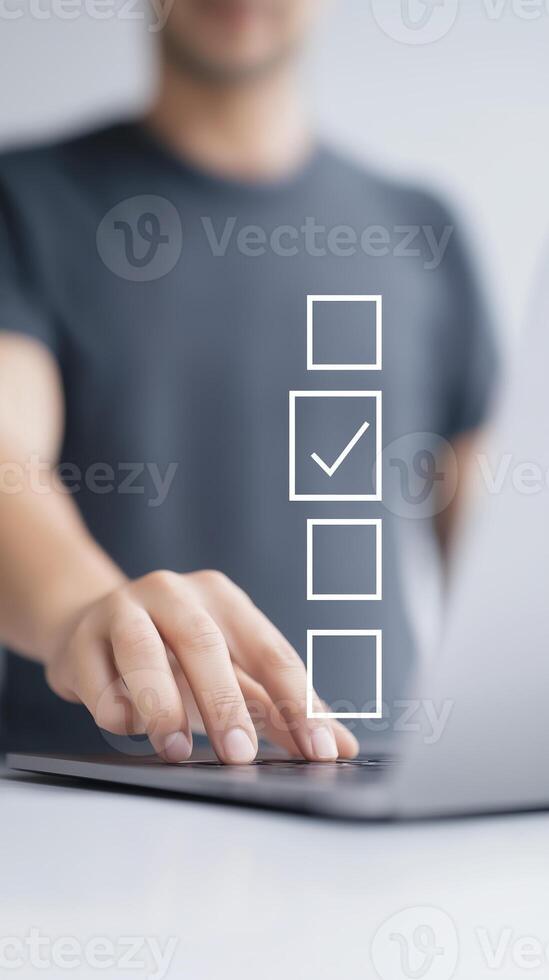 Man using laptop with check mark on screen photo