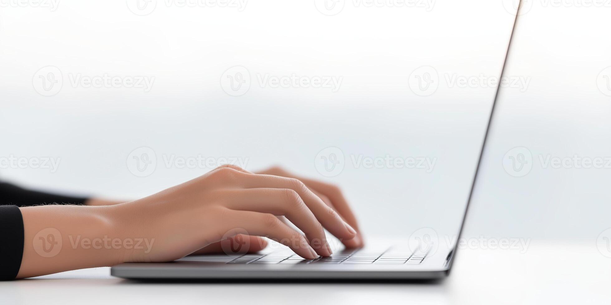 Hands typing on a laptop keyboard with a blurred background creating a modern workspace atmosphere and technology concept photo