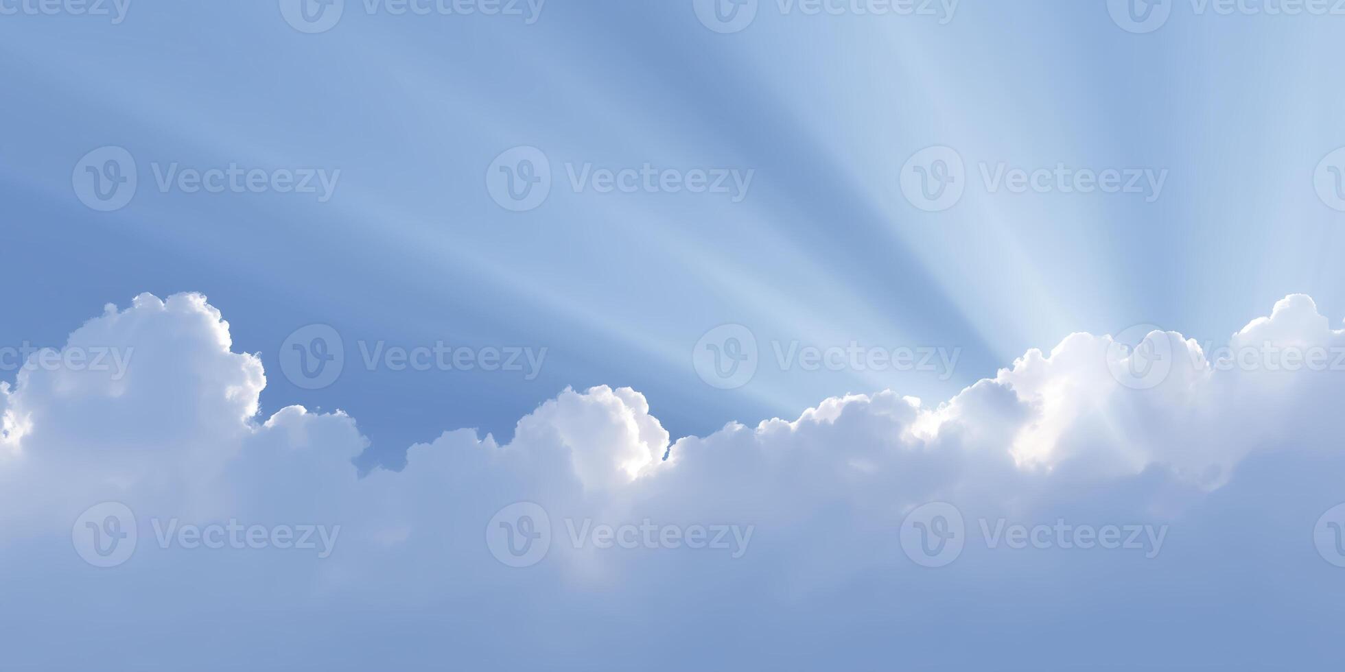 Soft white clouds illuminated by sunlight rays create a serene atmosphere in a clear blue sky, evoking feelings of peace and tranquility in nature's beauty photo